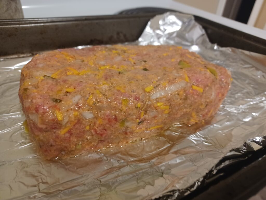 cheeseburger meatloaf before baking on sheetpan